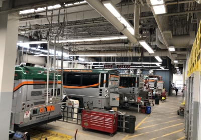 Garage with busses and overhead LED lighting
