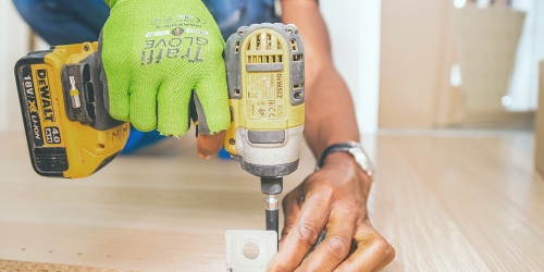 man drilling wood