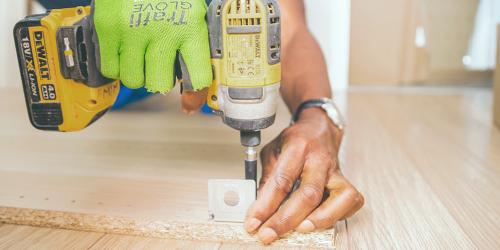 man drilling wood